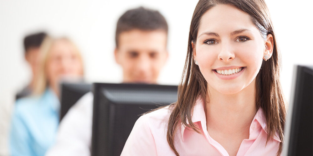 Smiling Student Using Computer